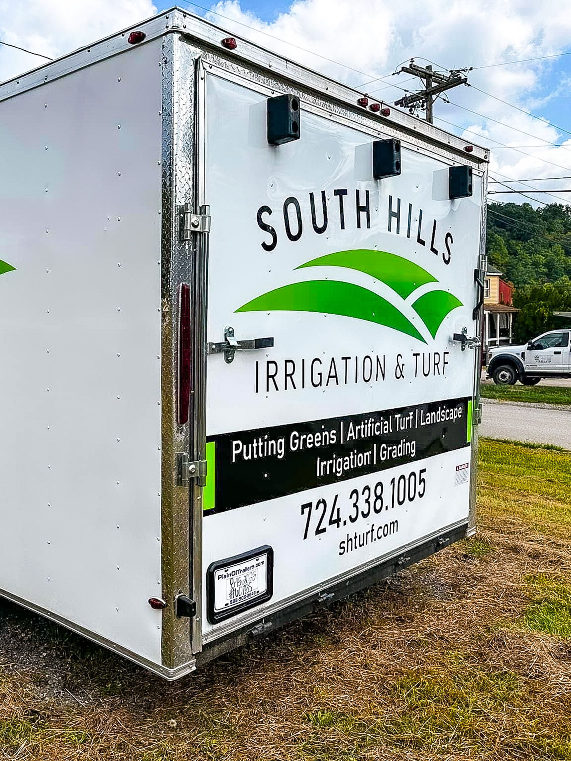 White trailer with "South Hills Irrigation & Turf" logo and contact information.