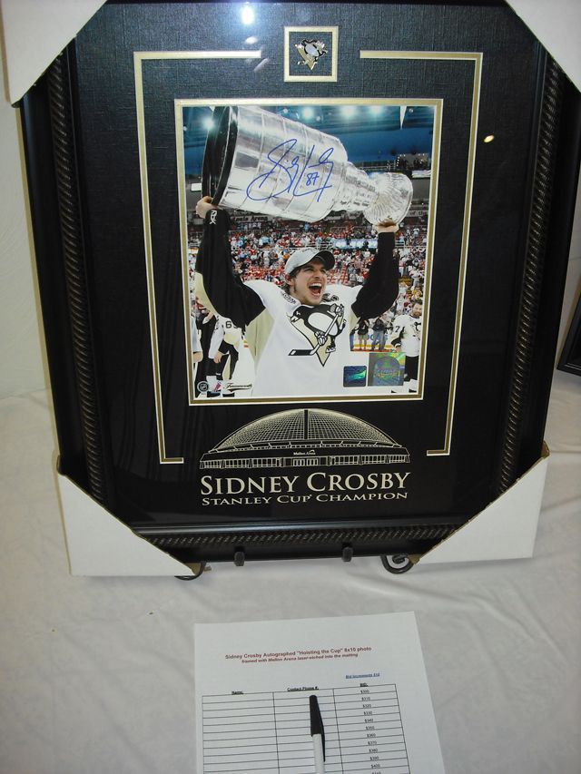 A framed picture of sidney crosby holding a flag