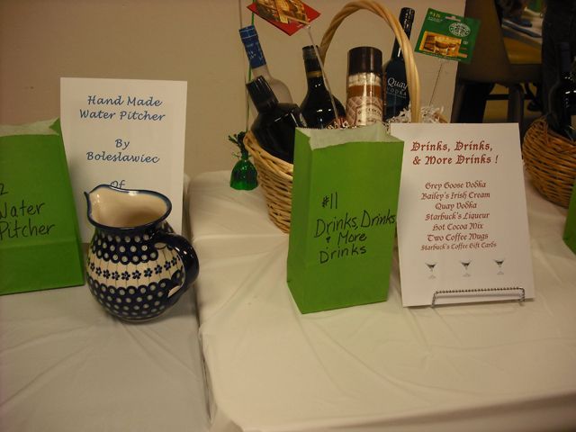 A table with green bags that say drinks drinks and more drinks