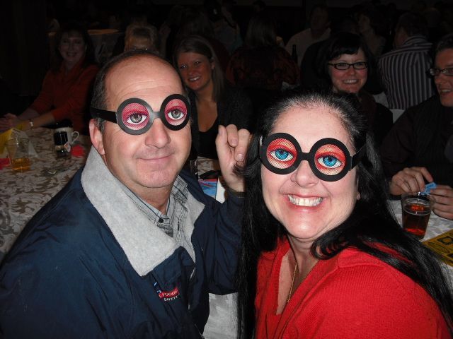 A man and a woman wearing fake glasses with blue eyes