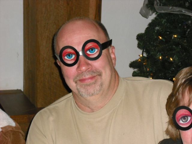A man wearing a pair of fake glasses with blue eyes