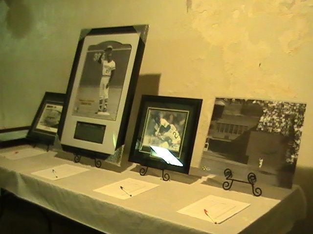 A table with a bunch of framed pictures on it