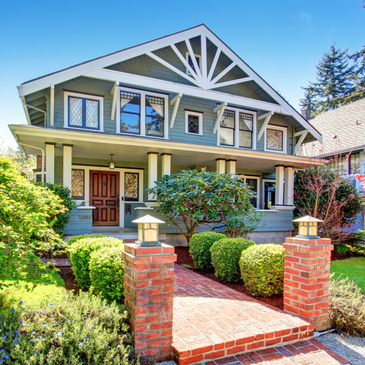 Craftsman-style two-story home in Boise with brick walkway, front porch, and manicured landscaping u