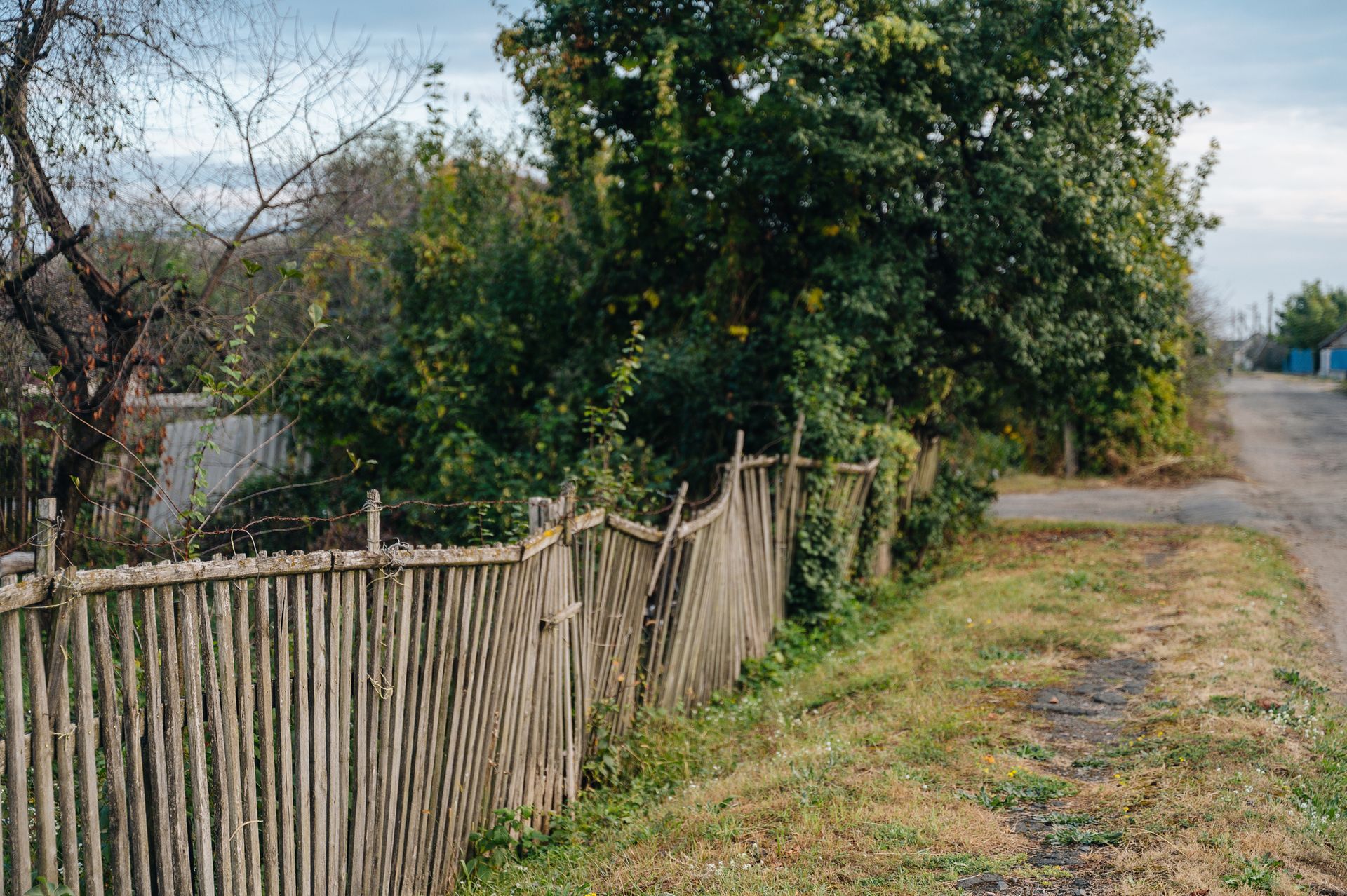 A bunch of old appliances are stacked on top of each other on the side of a building.