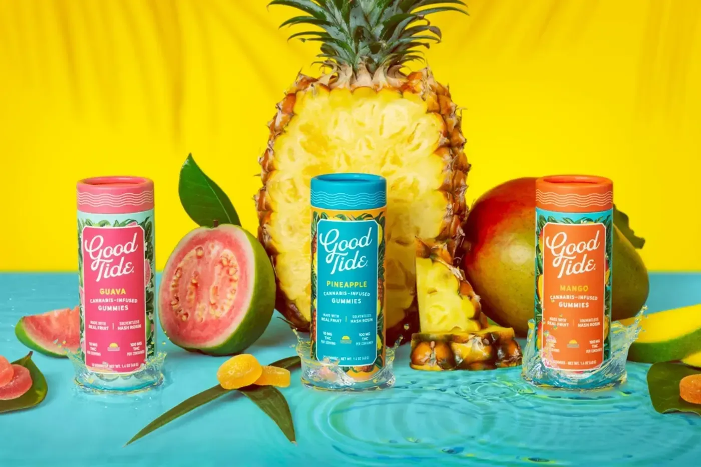 Bottles of Good Tide juice with pineapple, guava, and mango on a tropical background.