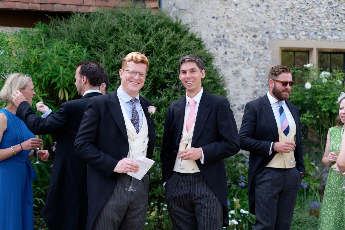 A group of men in suits and ties are standing in front of a building.