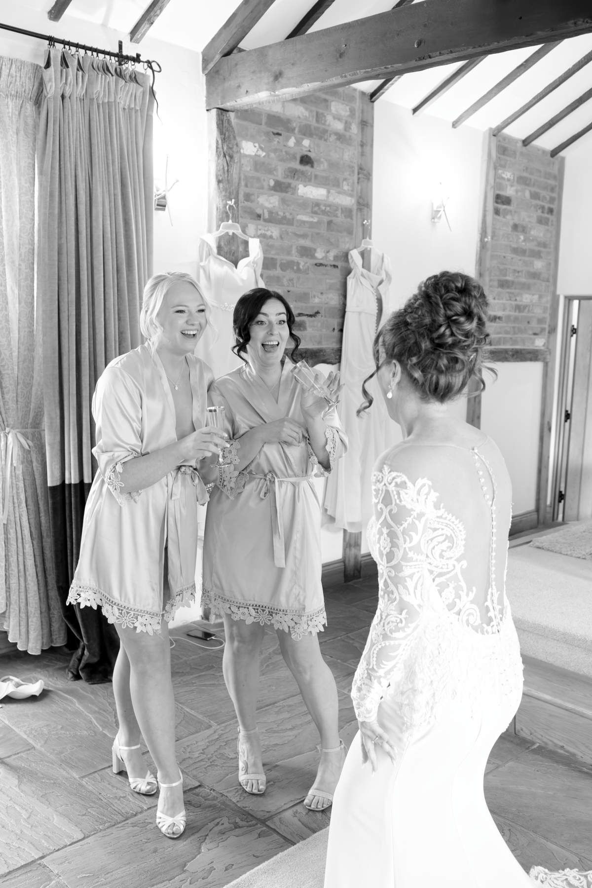 A bride and her bridesmaids are standing next to each other in a room.