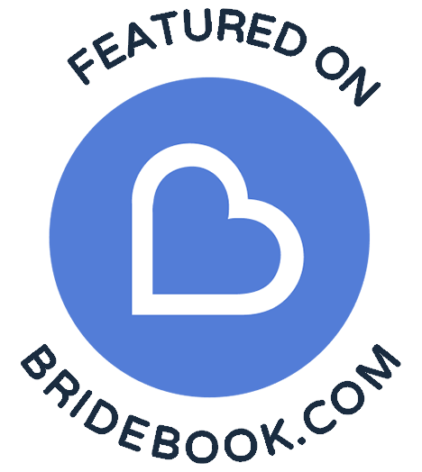 A badge that says `` featured on bridebook.com '' with a heart in a blue circle.