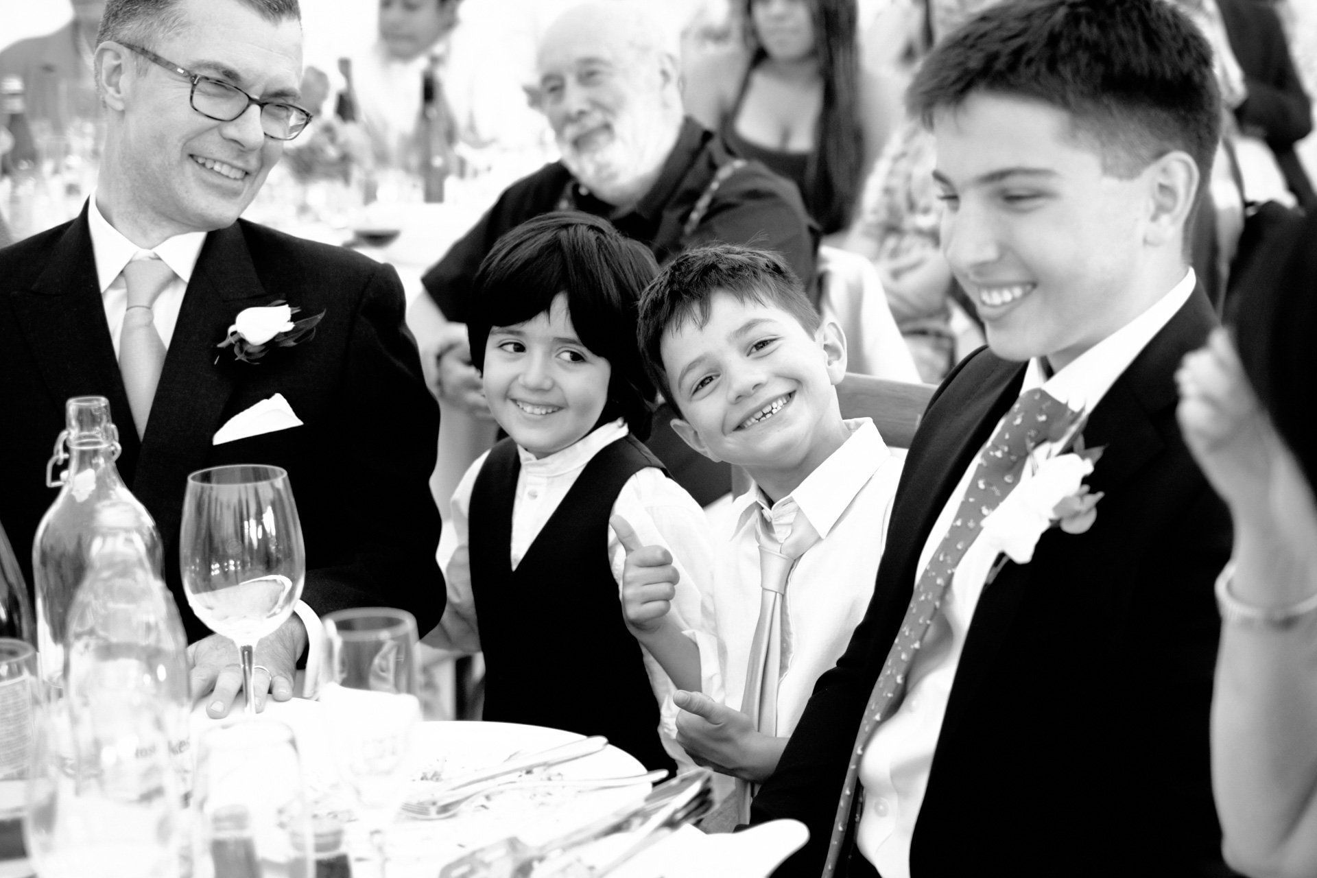 A black and white photo of a group of people sitting at a table.