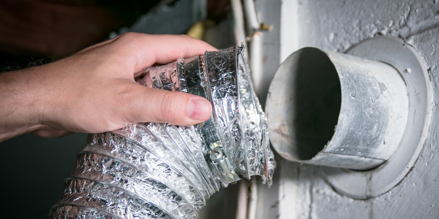 A person is holding a flexible duct in their hand.