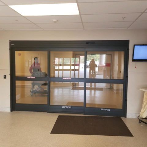 A hospital room with a sliding glass door