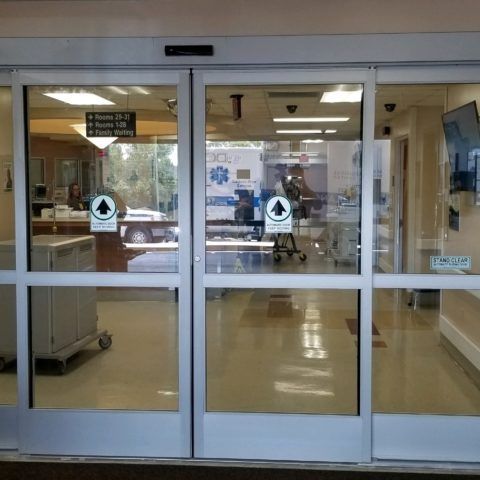 A hospital entrance with a sliding glass door