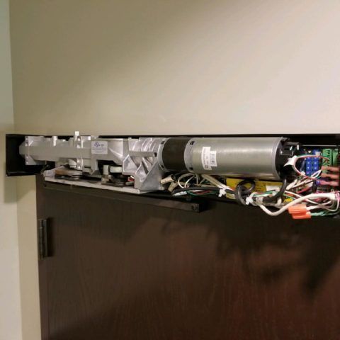 Automatic Doors Installation and Repair - The inside of a door with a motor and wires.