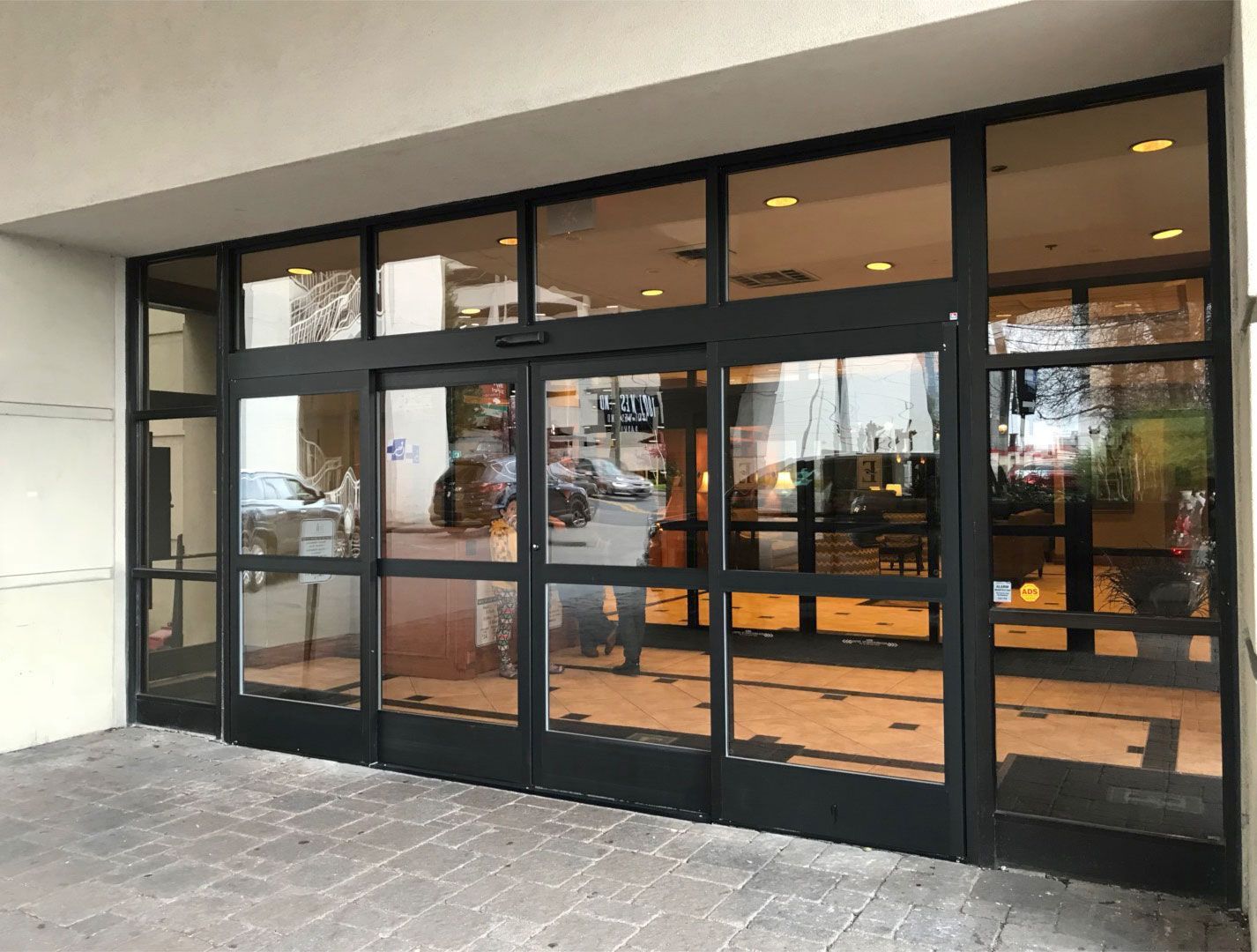 A large building with a lot of windows and a sliding glass door.