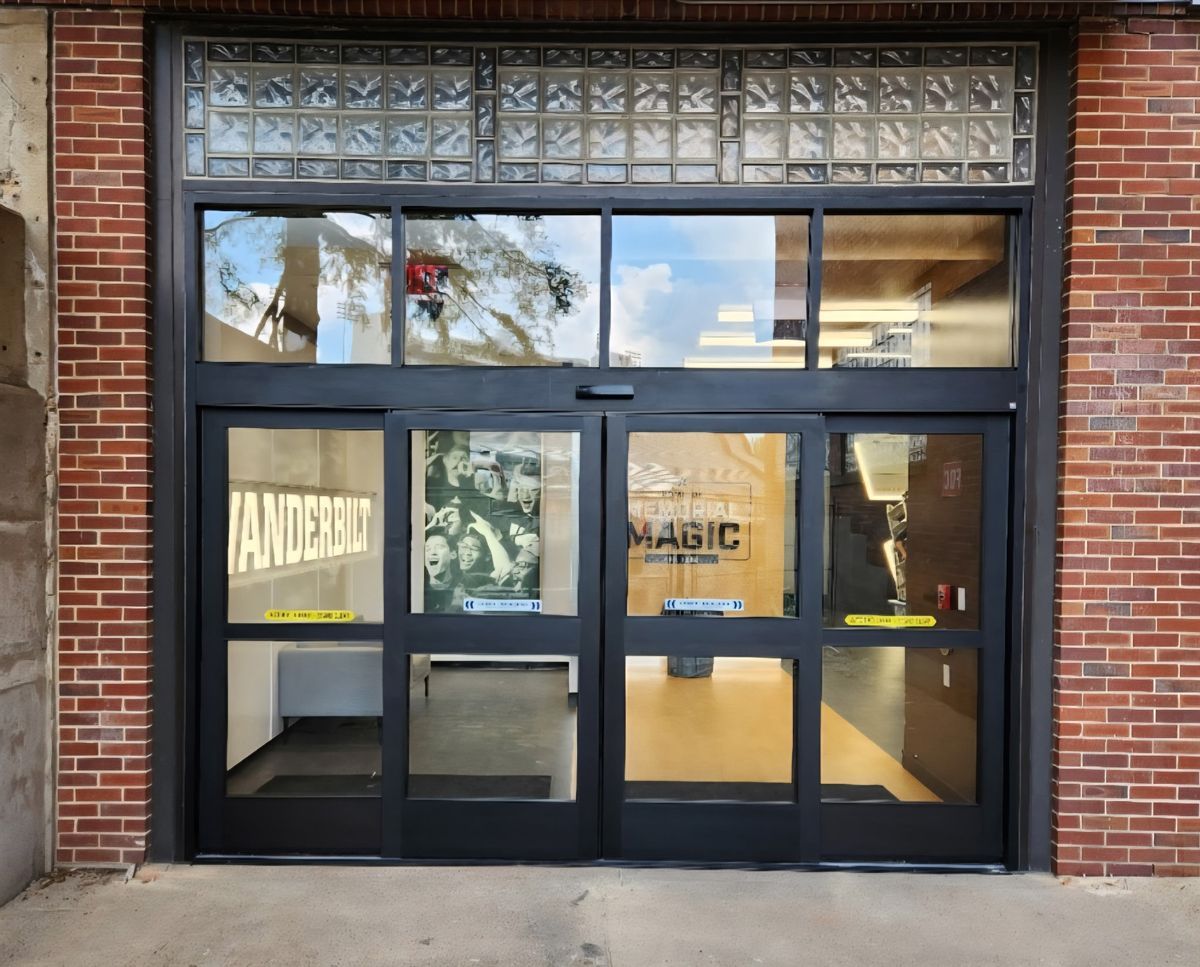 A brick building with a sliding glass door and a sign that says wanderlust