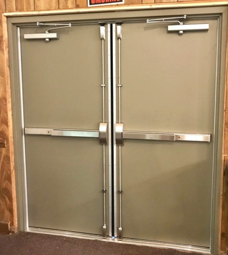 A pair of doors with a warning sign above them