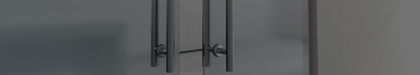 A close up of a refrigerator door with long handles.