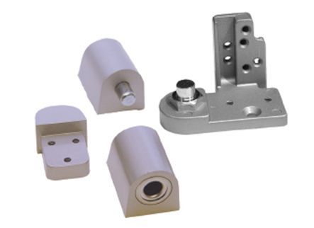 A bunch of metal pieces are sitting on top of each other on a white surface.
