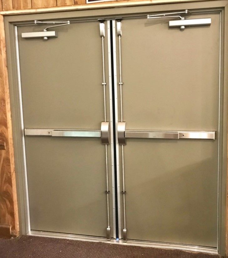 A pair of doors with stainless steel bars on them