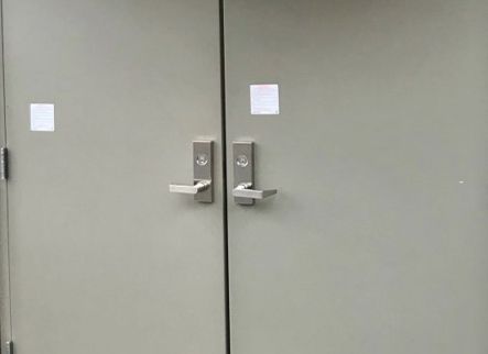 A close up of a pair of doors with stainless steel handles.