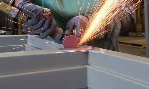 Nashville Commercial Door Installation and Repair Technician repairing a commercial steel roll-up doo