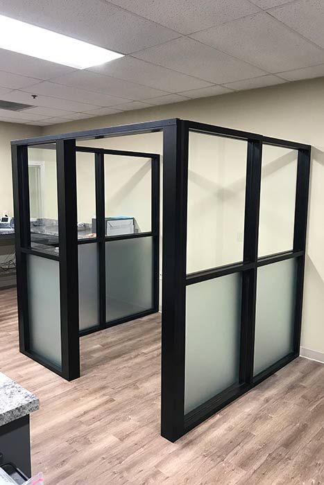 A room with a lot of windows and a wooden floor.