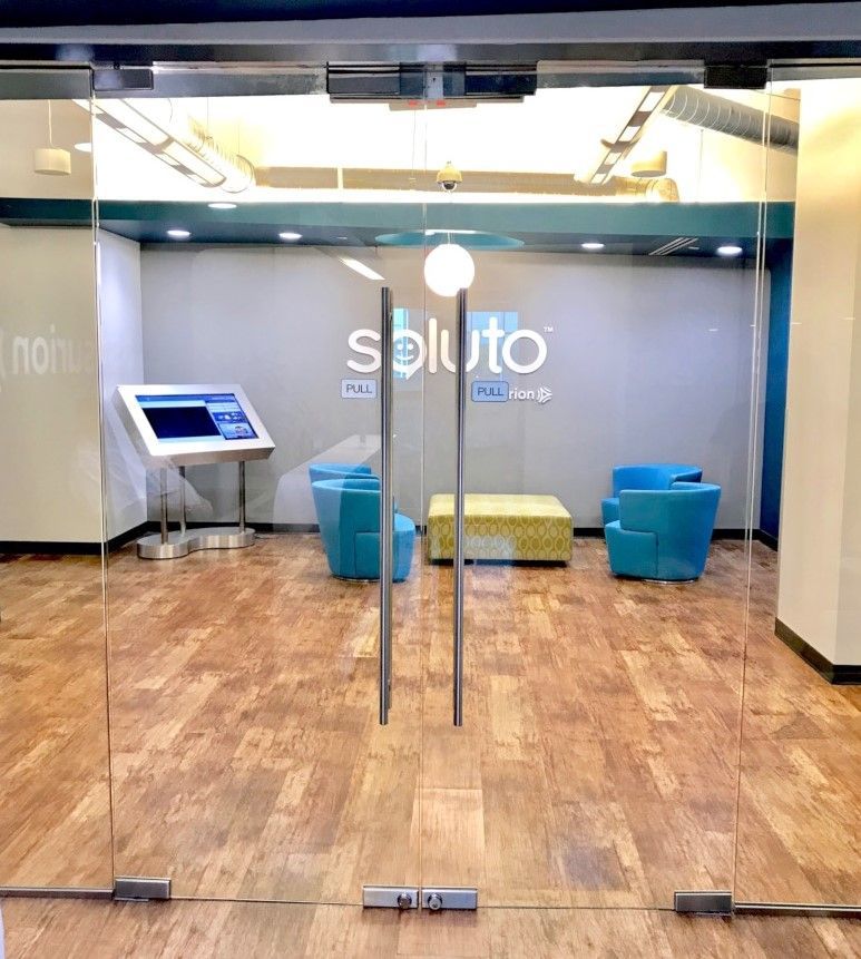 Storefronts & Glass Doors Installation and Repair - A room with a sign that says soluto on it