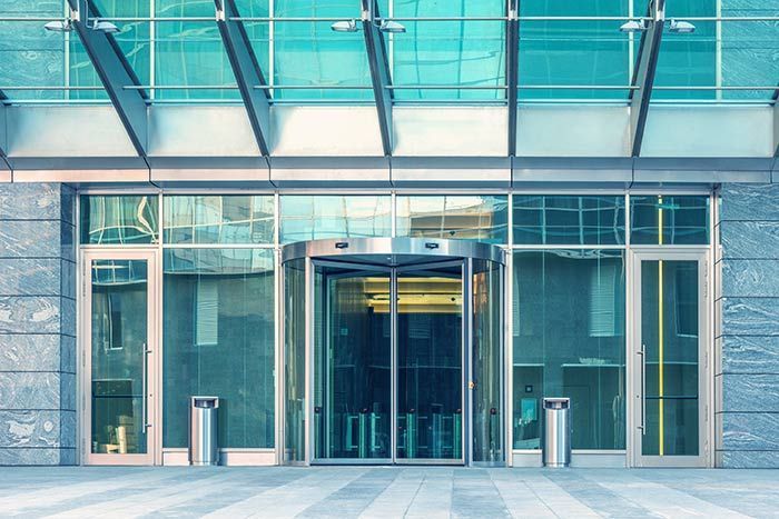 Automatic Doors Installation and Repair - A large building with a revolving door and a glass roof.