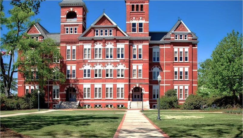 A large red brick building with a walkway leading to it