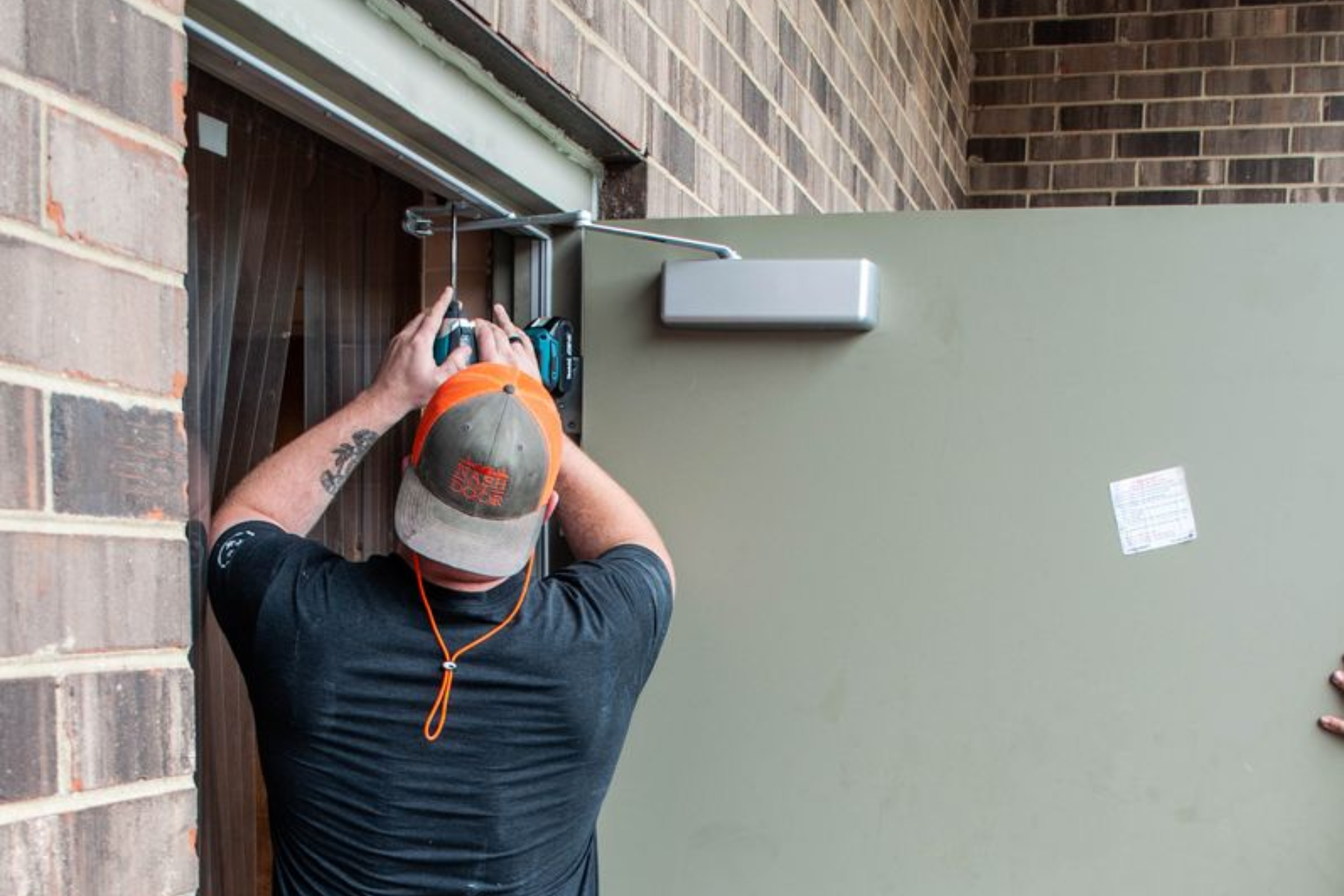Nashville Commercial Door Installation and Repair - Two men are posing for a picture in a restaurant.
