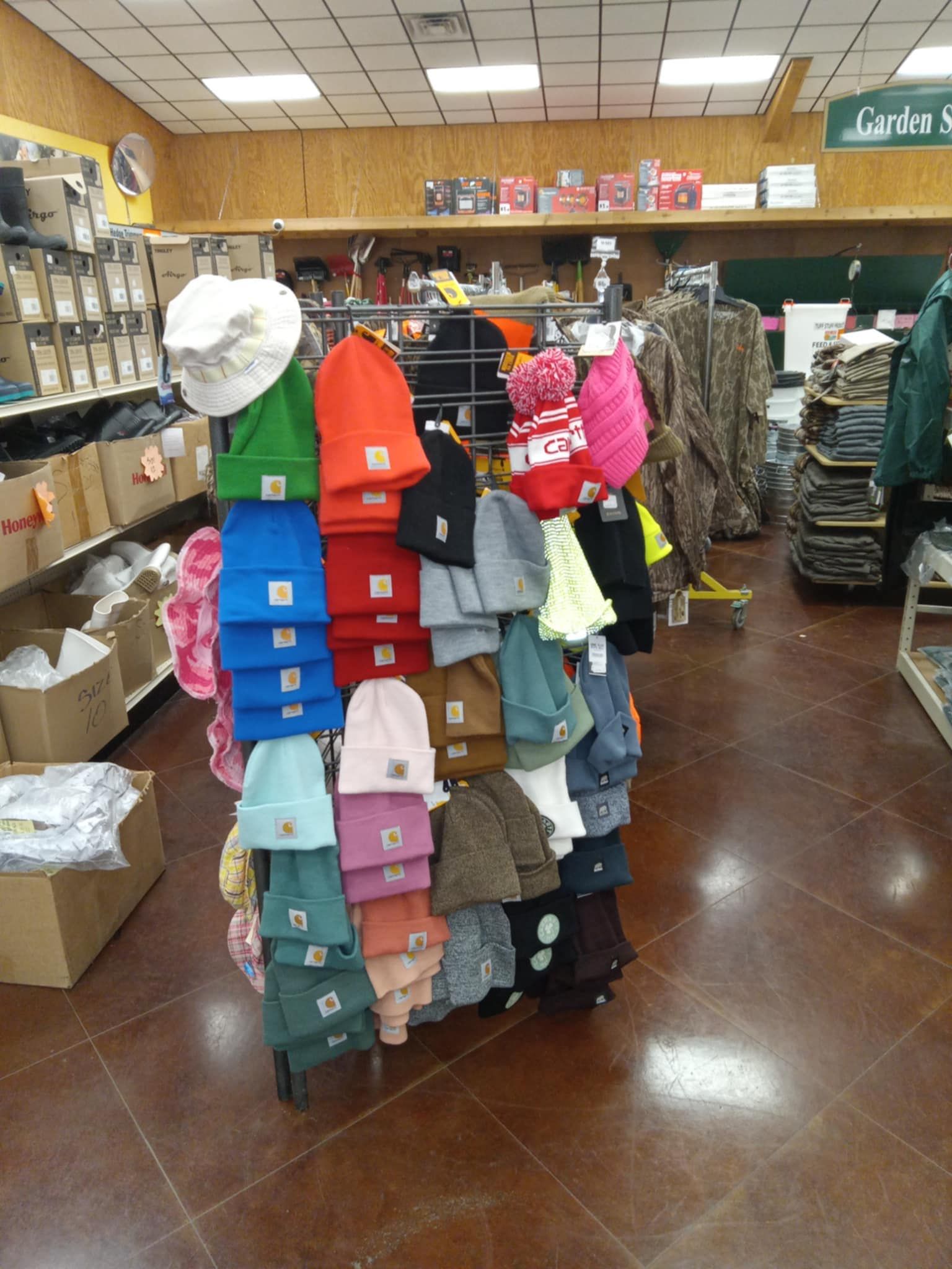 A bunch of hats and gloves are sitting on a wooden table.