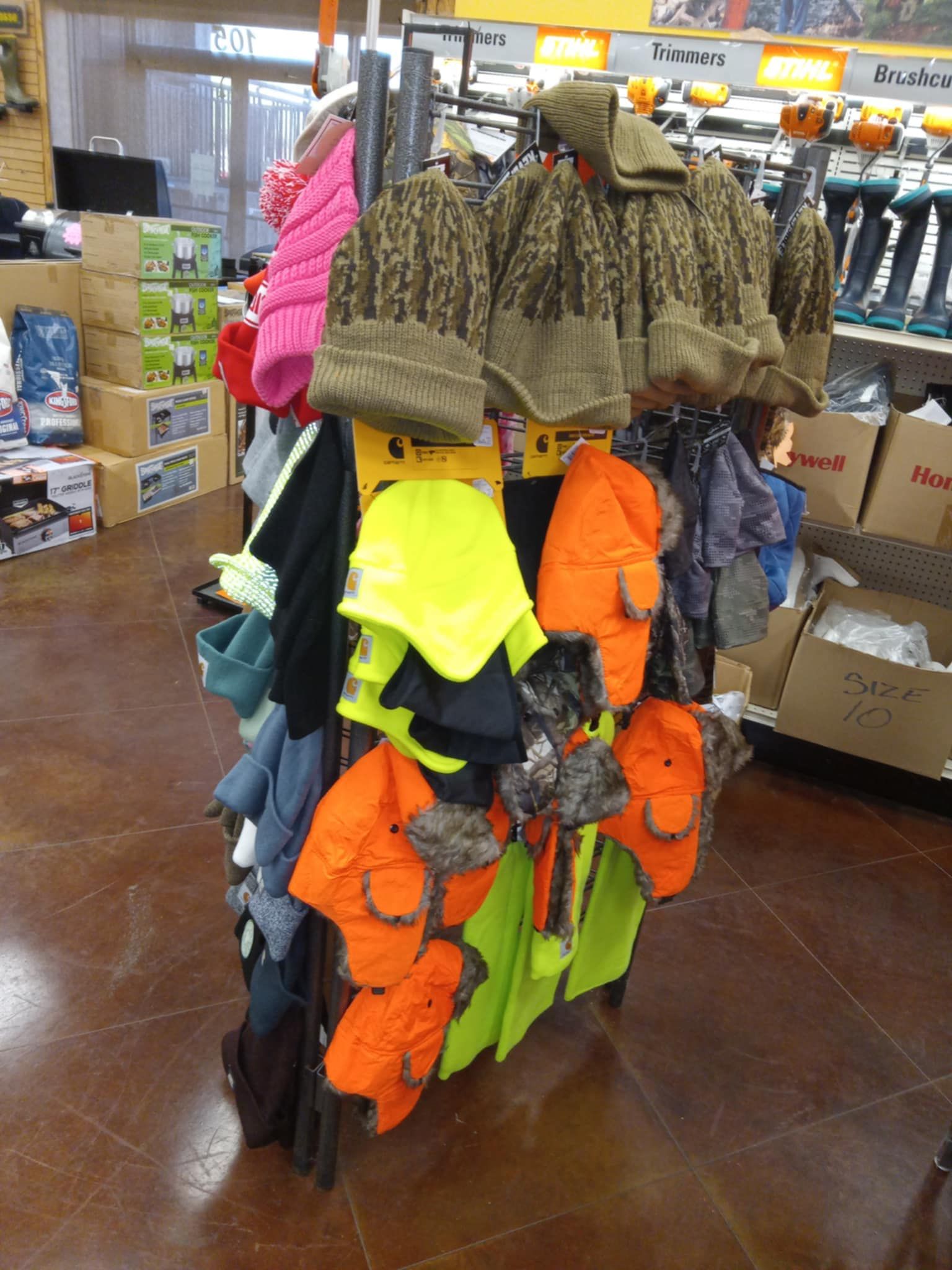 A bunch of hats are hanging on a rack in a store