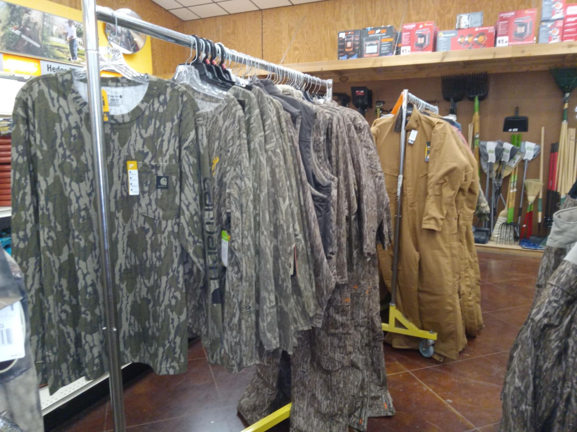 A bunch of clothes are hanging on racks in a store