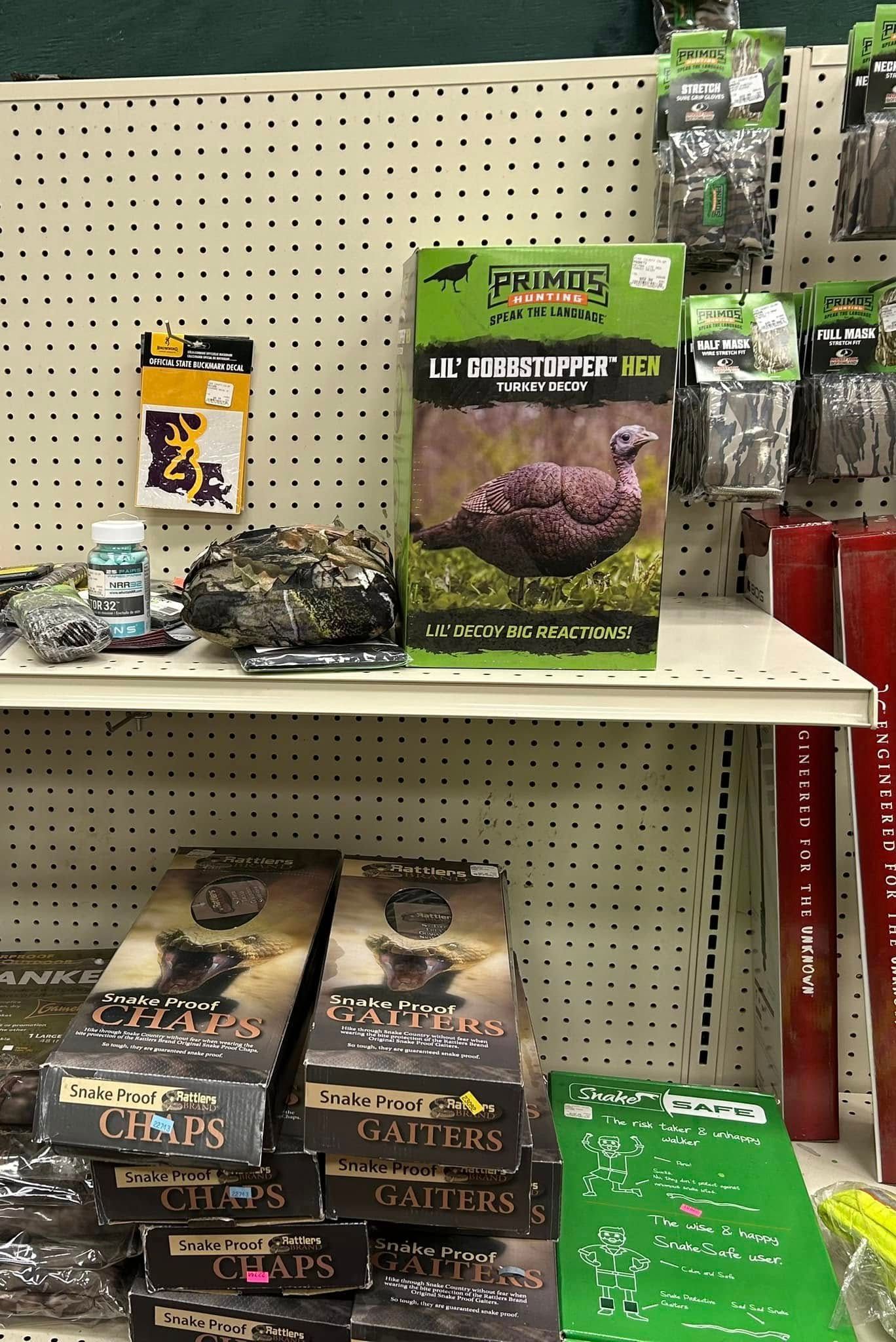 A shelf in a store filled with lots of hunting items.