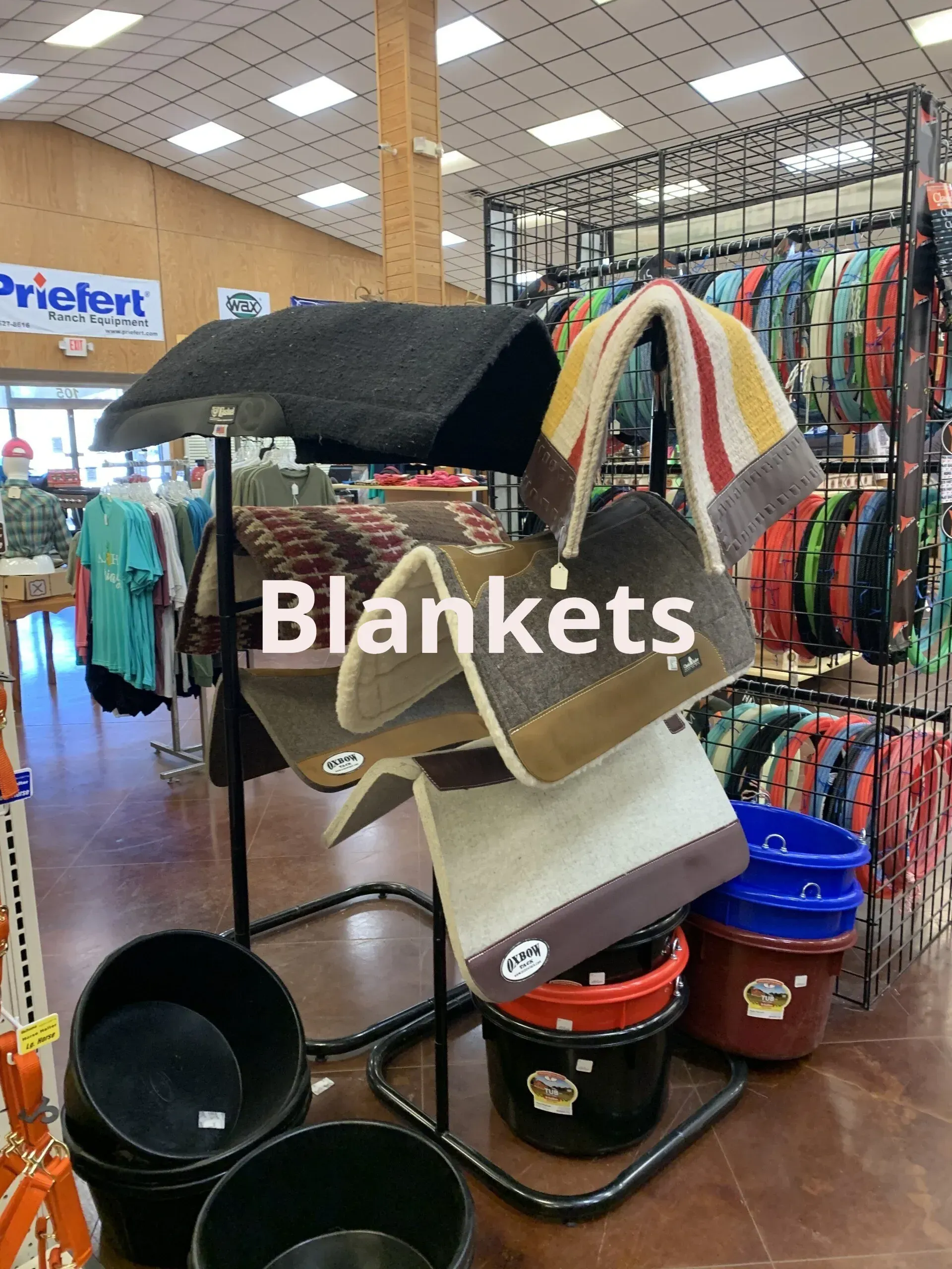 Blankets are displayed on a rack in a store.