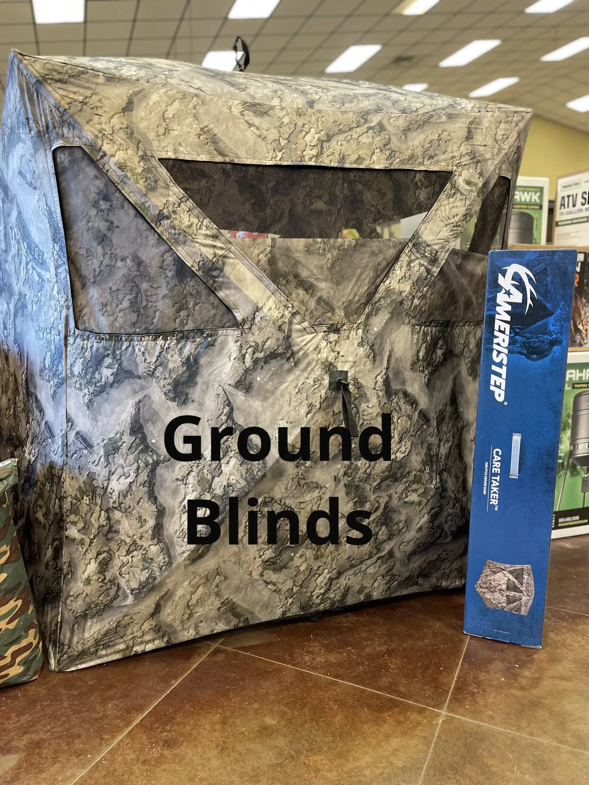 A ground blind is sitting on a tiled floor in a store.