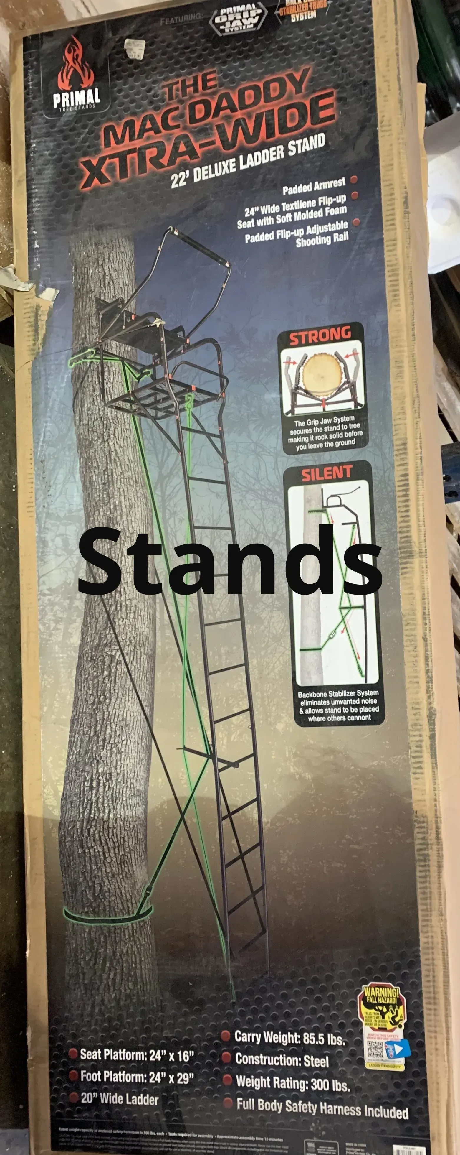 A ladder is sitting on top of a wooden table next to a box.