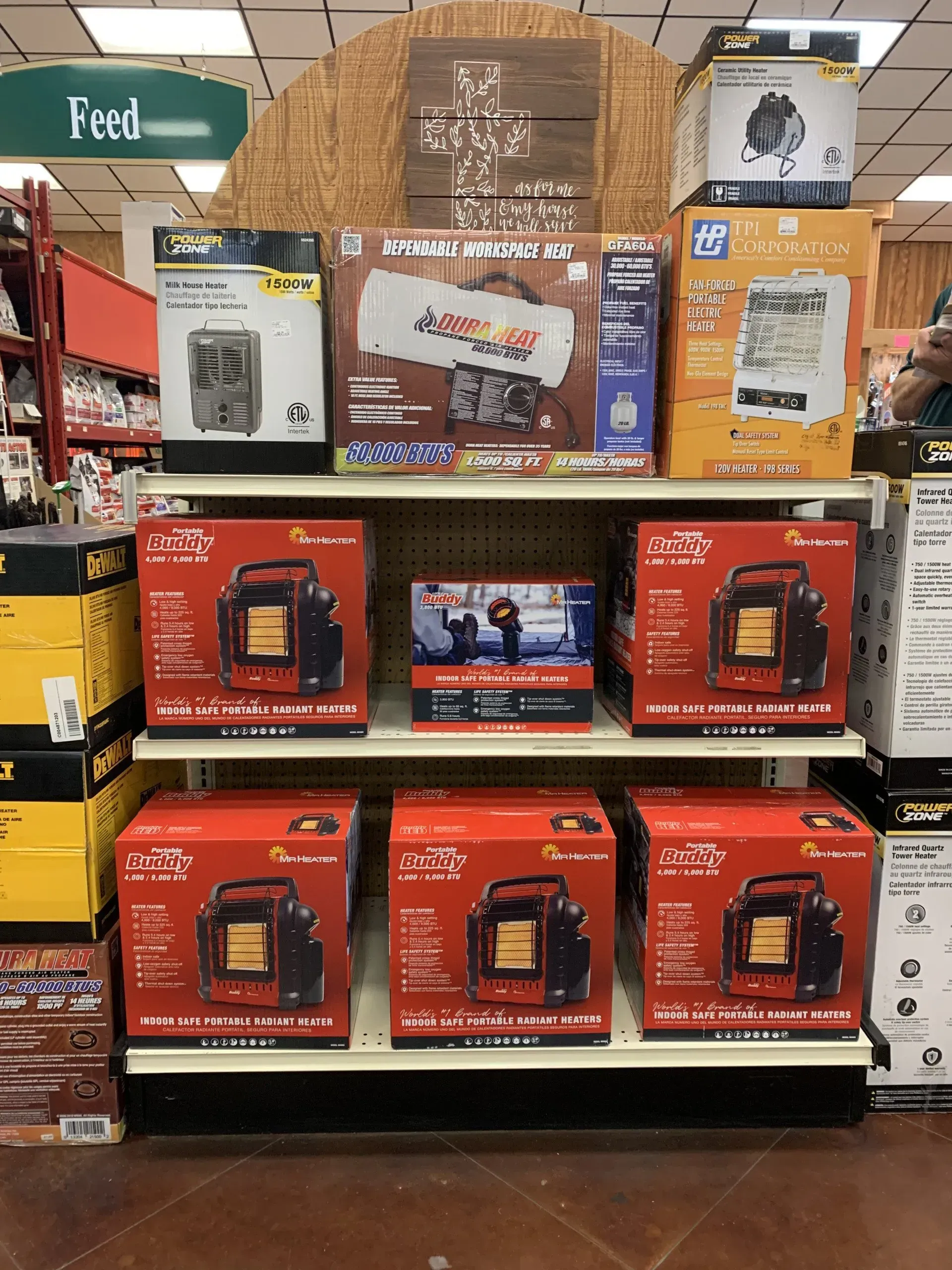 A shelf filled with boxes of heaters and cameras in a store.