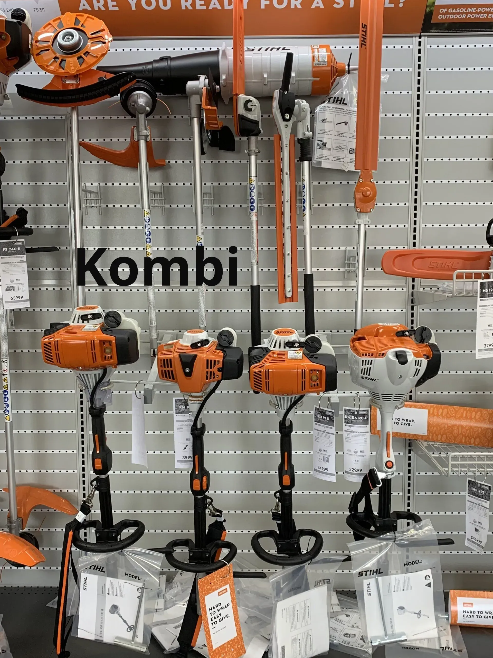 A display of stihl kombi trimmers in a store.