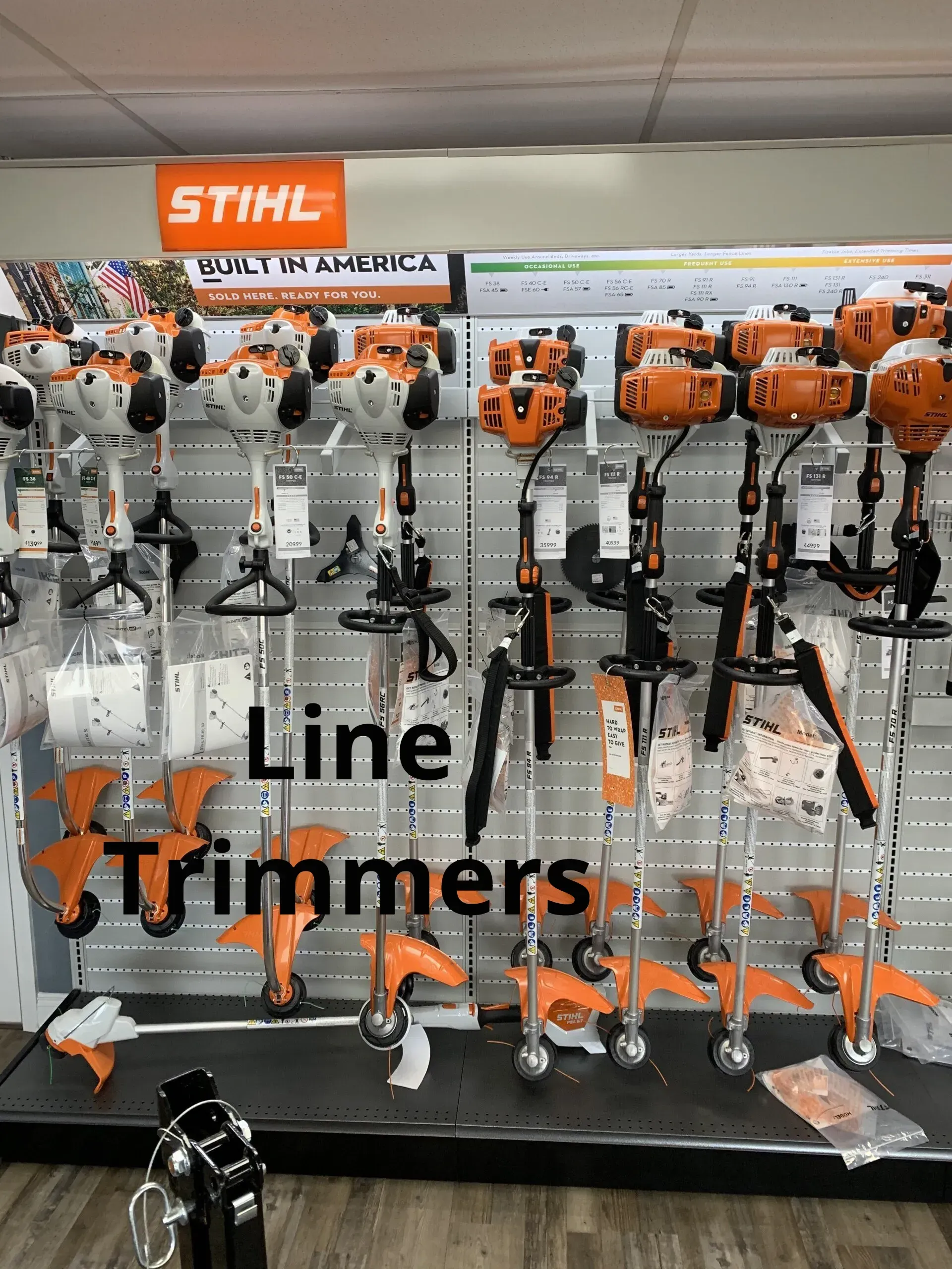A display of stihl line trimmers in a store.