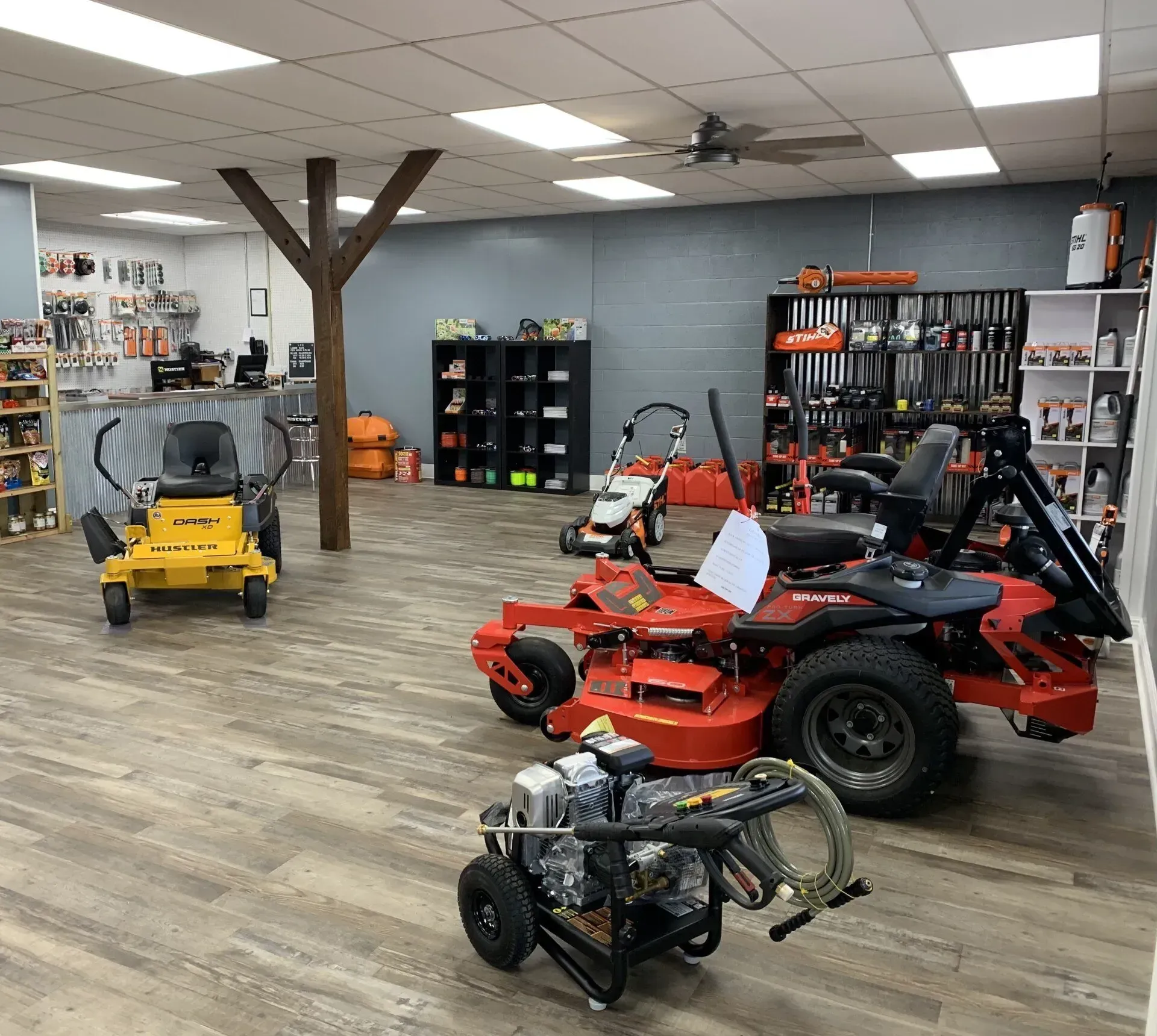A showroom filled with lawn mowers and a water pump.
