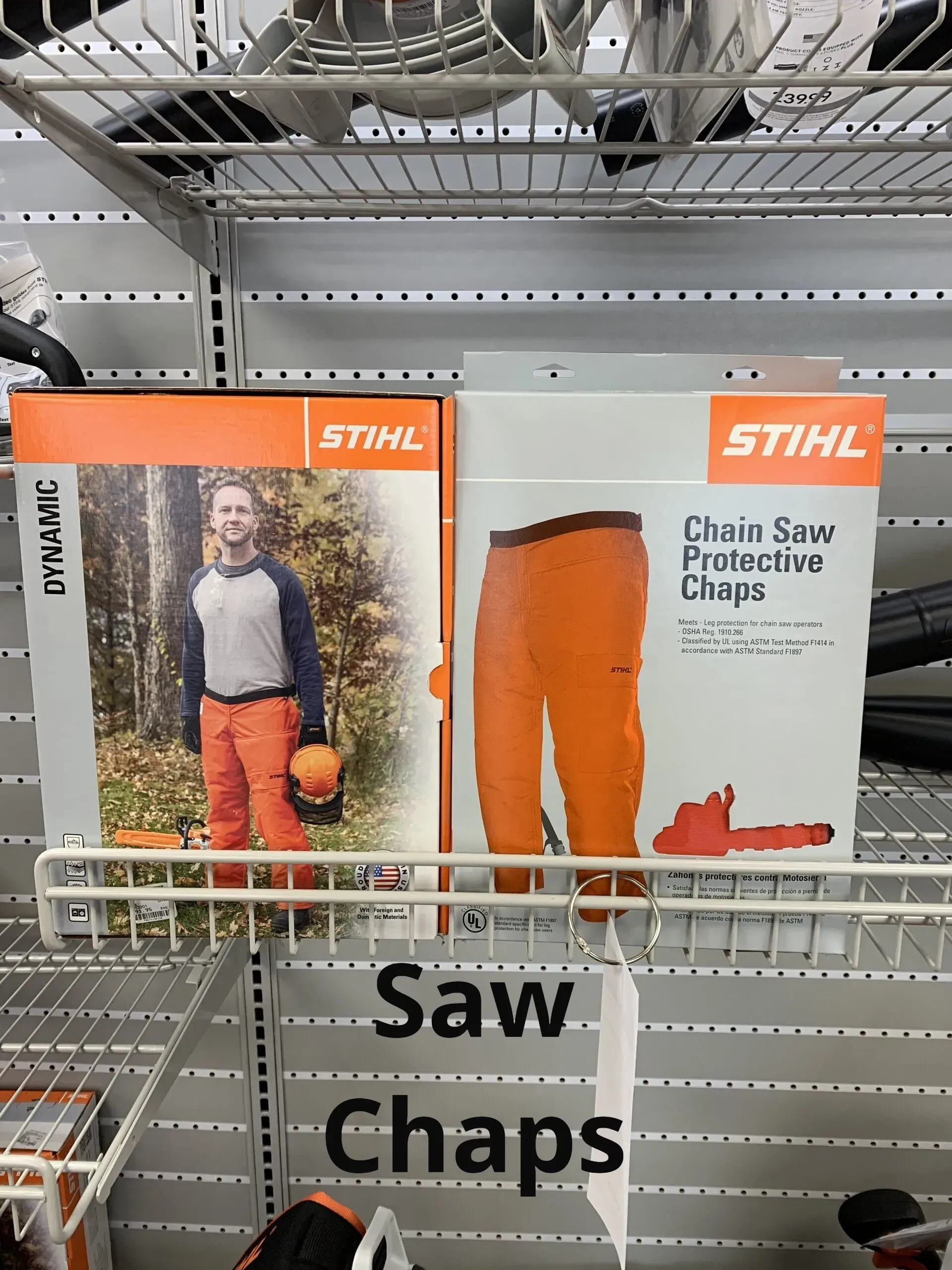 Two boxes of stihl chainsaw chaps are on a shelf