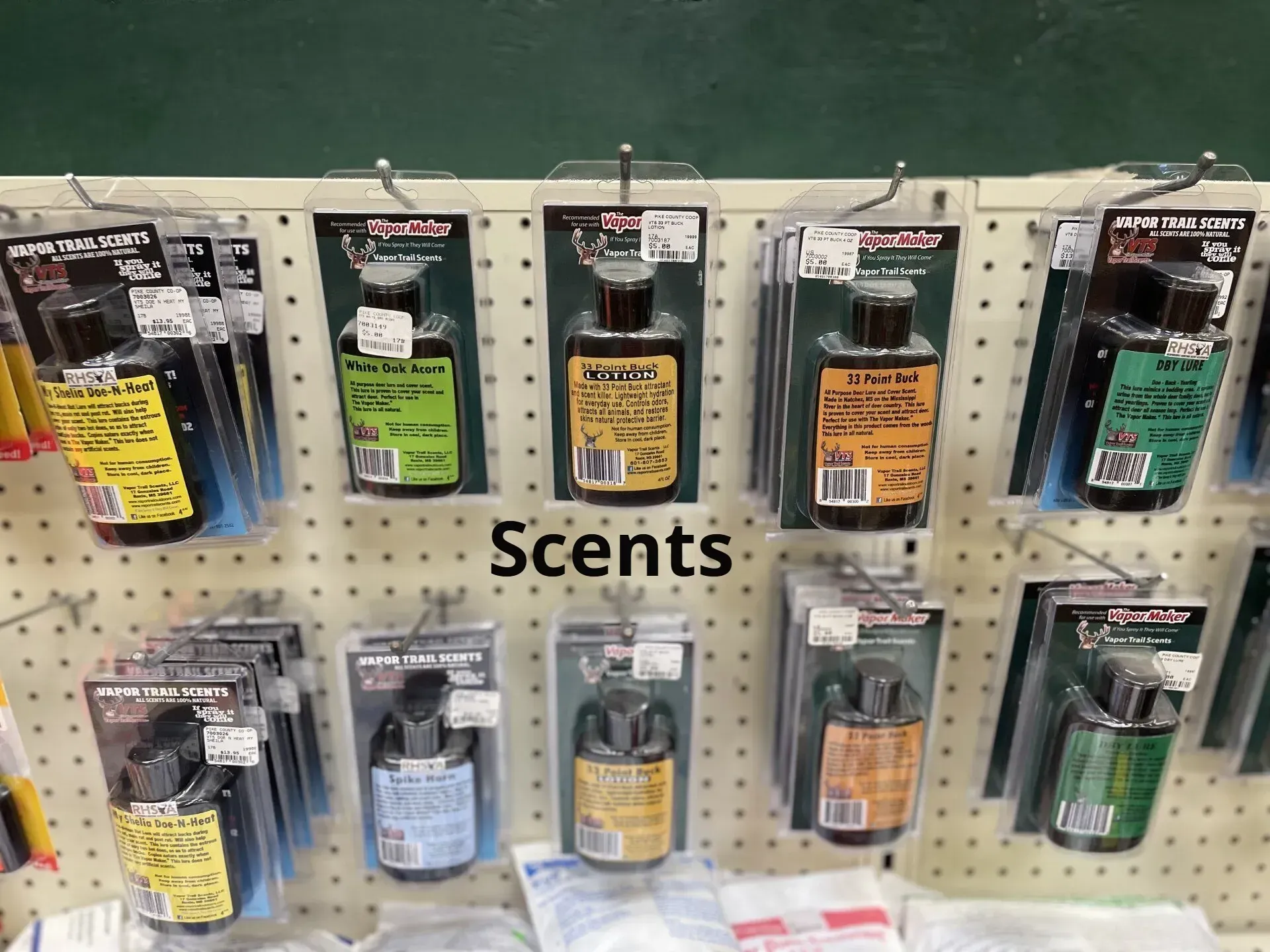 Several bottles of scents are displayed on a wall