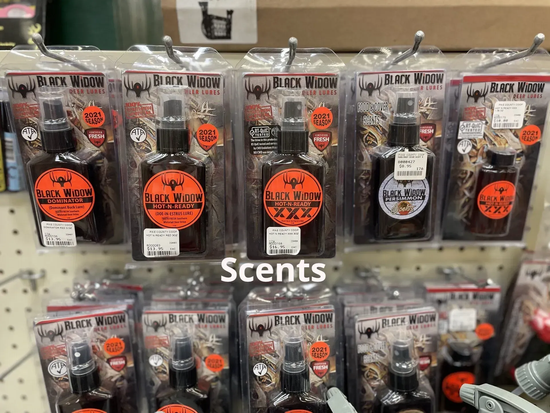 A display of scents hanging on a wall in a store.
