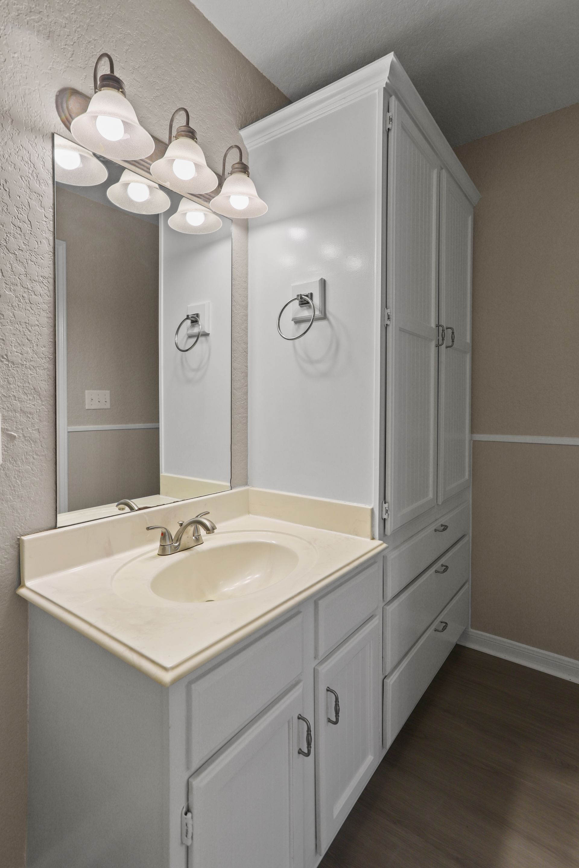 Photo of a bathroom sink next to a built-in closet
