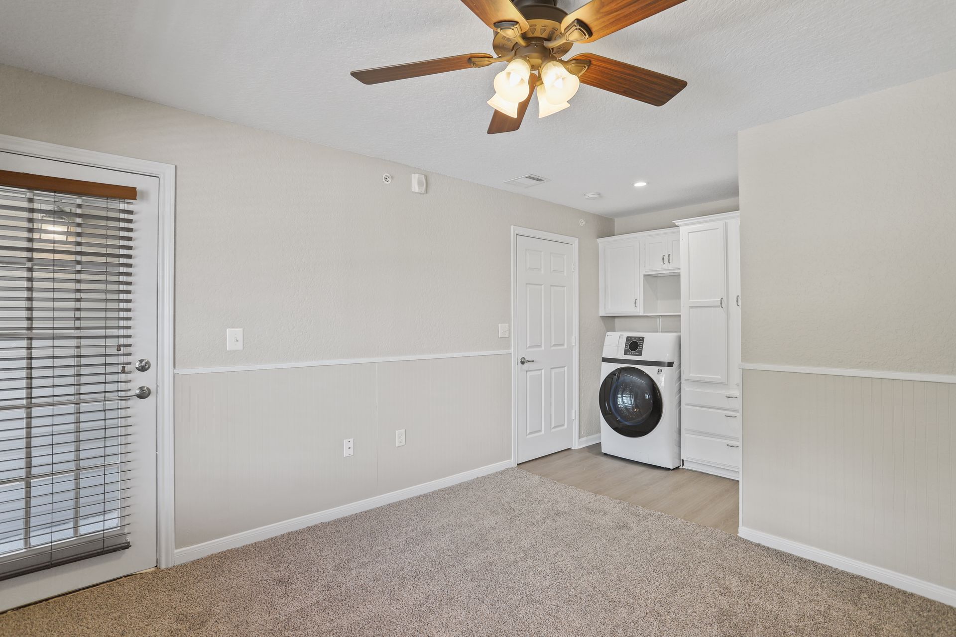 Photo of a room with the washer and dryer in the background