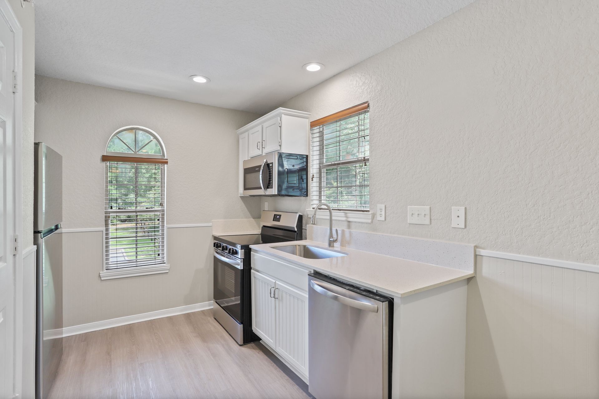 Photo of a kitchen with appliances and plenty of natural lighting