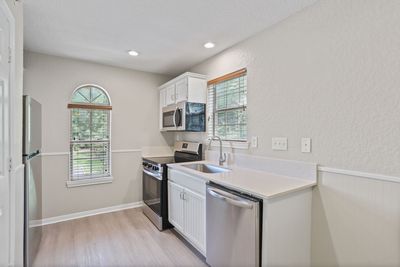 Photo showing a kitchen with plenty of natural lighting, and a compact-style setup