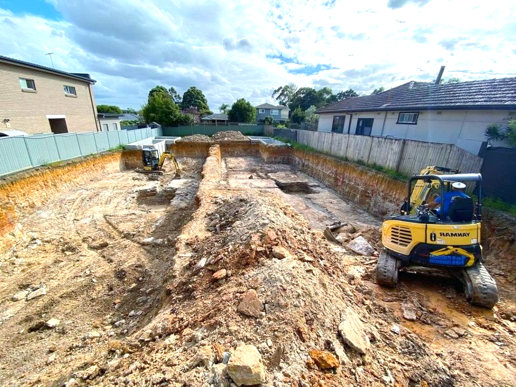A construction site with a bulldozer moving dirt and rocks.