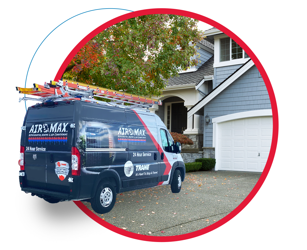 A van with a ladder on top of it is parked in front of a house.